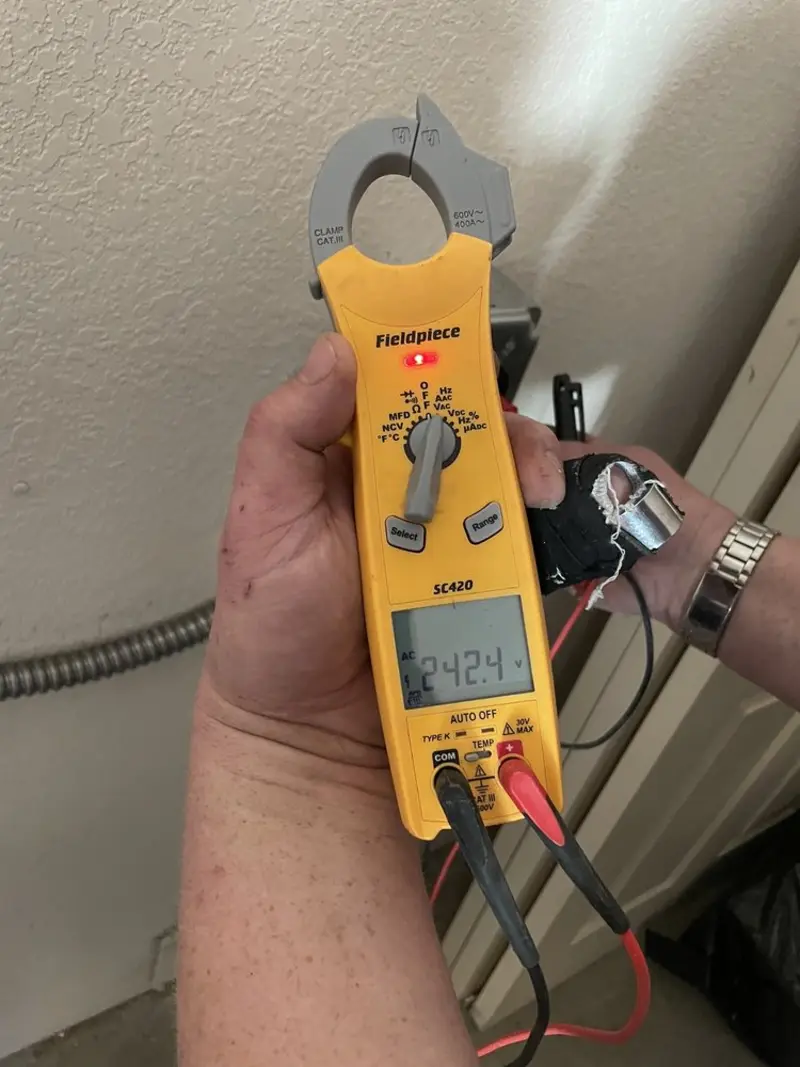 Voltage testing with clamp meter during Whole House Surge Protector in Owasco